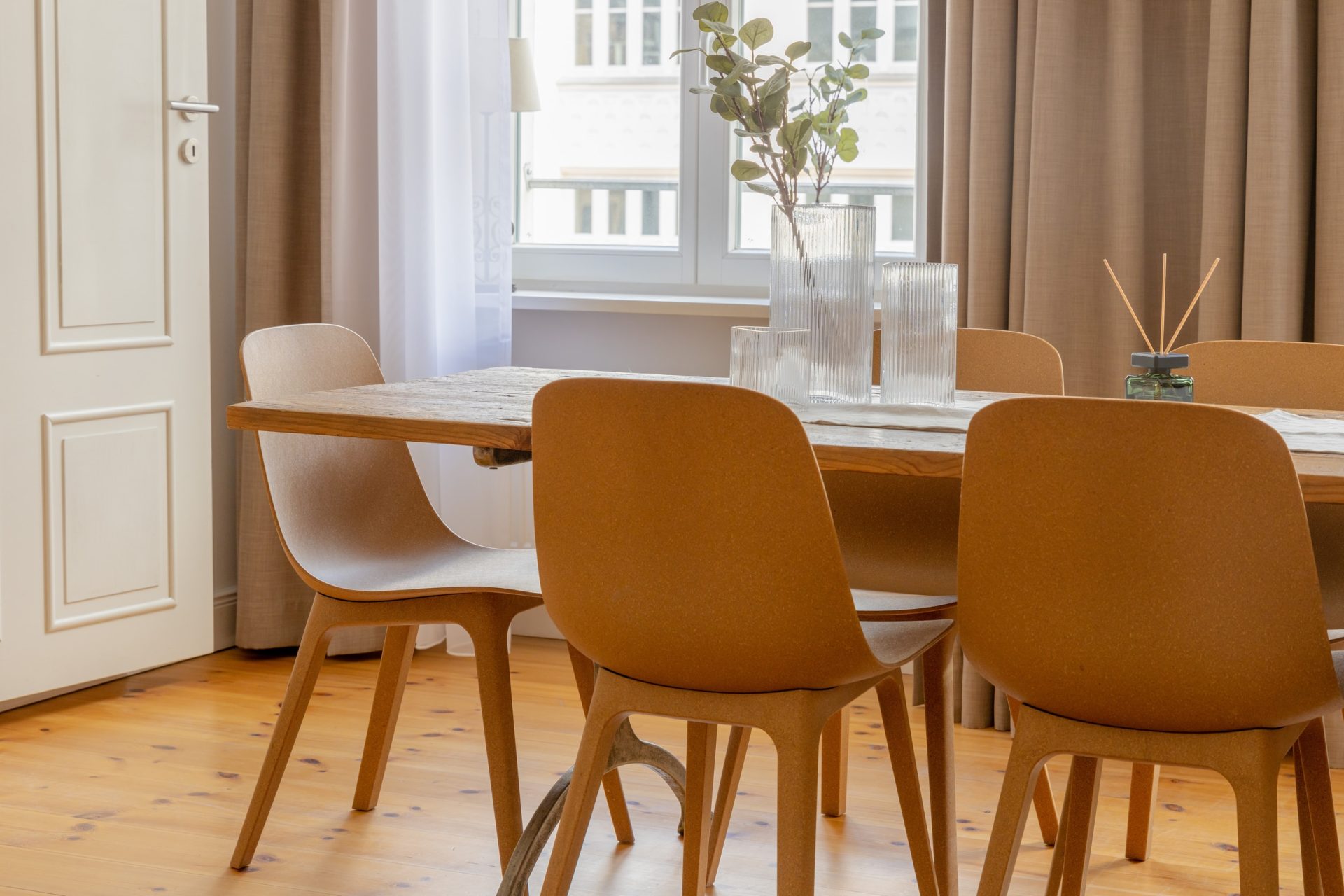 Bright dining room with wooden table and orange chairs